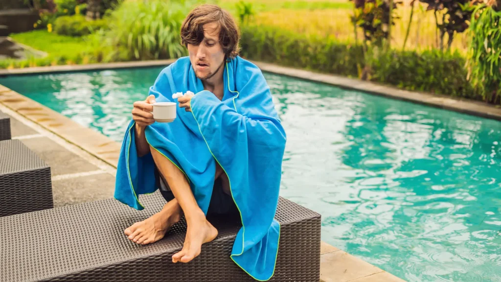 Man sitting poolside looking unwell
