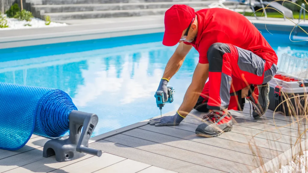 Technician installing a safety pool cover to prevent animals from falling in Miami