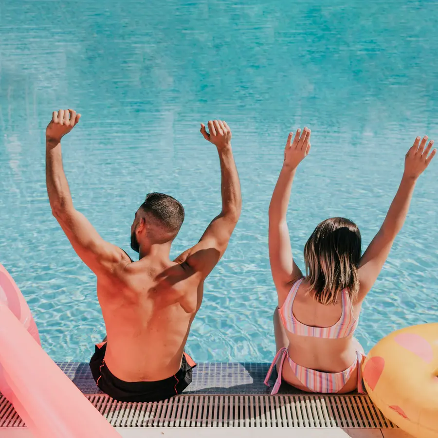 Romantic couple vacationing in an Orlando Florida backyard swimming pool
