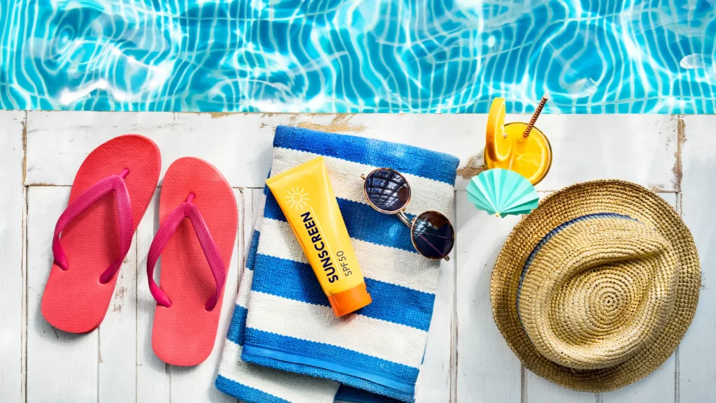 Poolside essentials including towels, sunscreen, and floaties