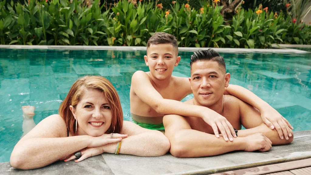 Happy family enjoying a clean pool thanks to a cartridge filter