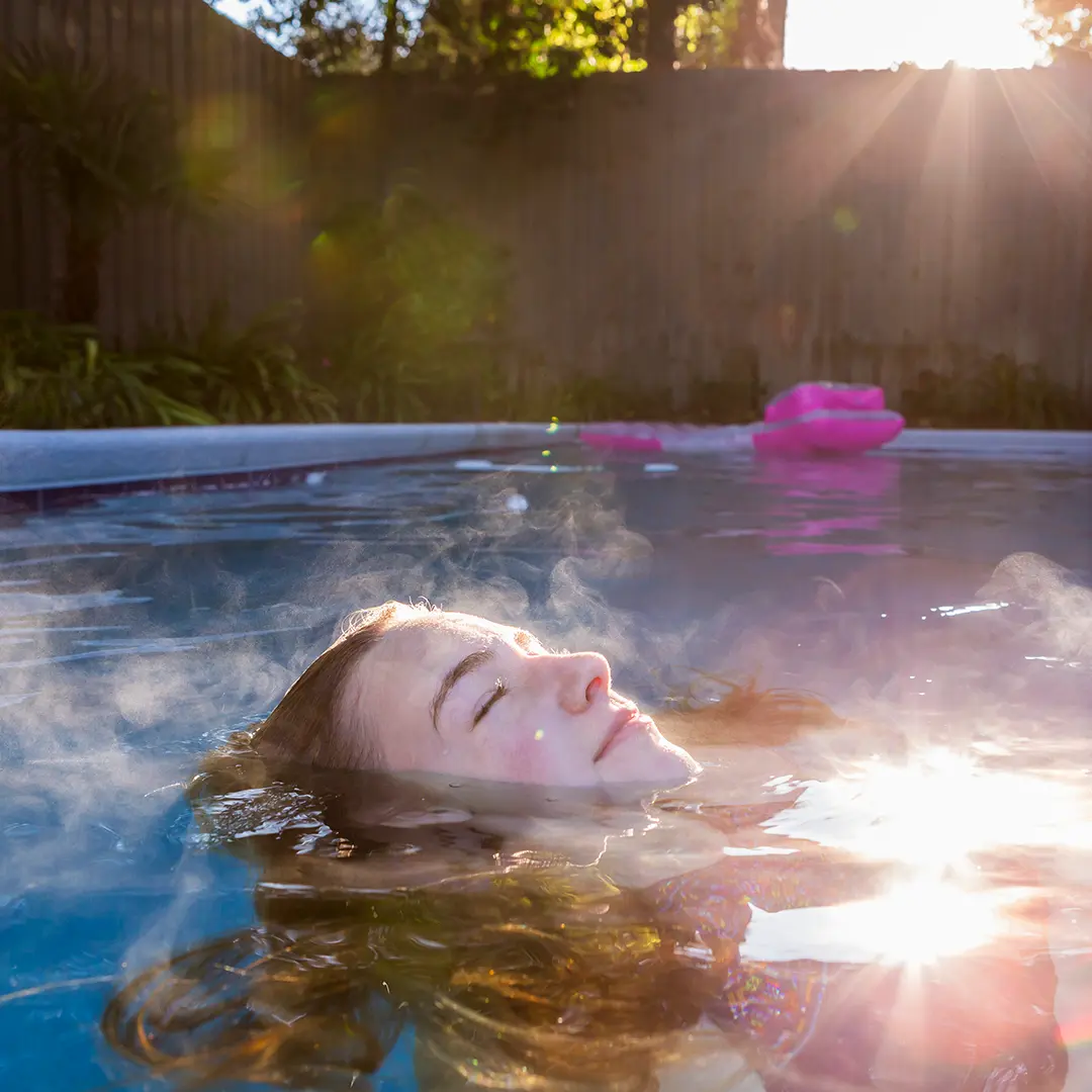 Girl enjoying warm pool time thanks to pool heater
