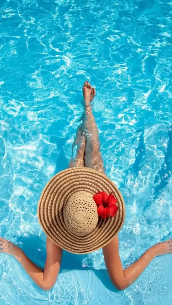 A woman relaxing on a pool captured from a cenital (top-down) perspective.