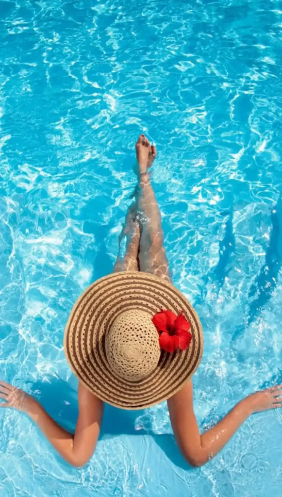 Woman relaxing in heated residential swimming pool