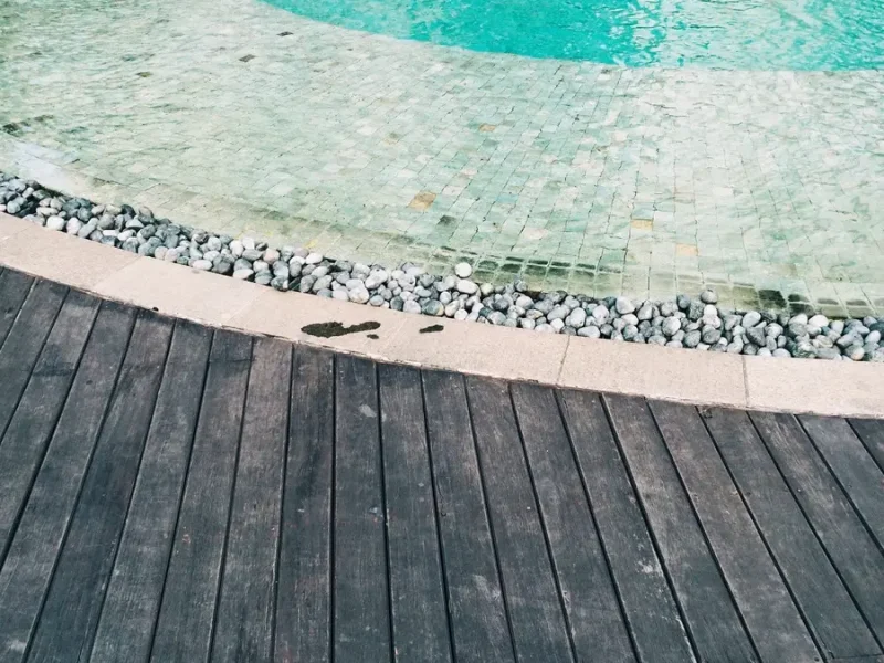 Natural rock pool border design creating a luxurious organic look for backyard swimming pools
