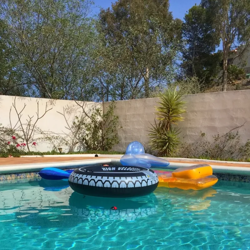 A fun Tucson pool with colorful floaters for kids, safely maintained by professional pool services in Tucson.