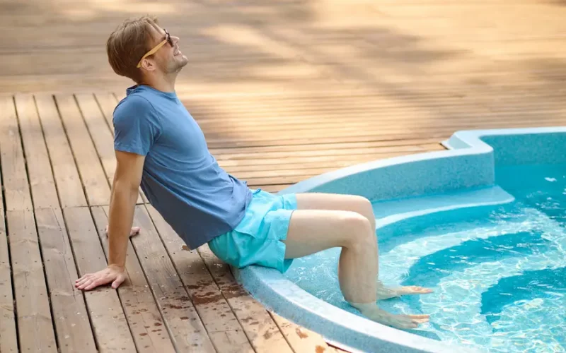 Smiling man enjoying accessible spa with safety rails for comfortable hydrotherapy