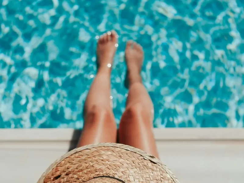 Girl dipping her toes in a serene pool for ultimate relaxation