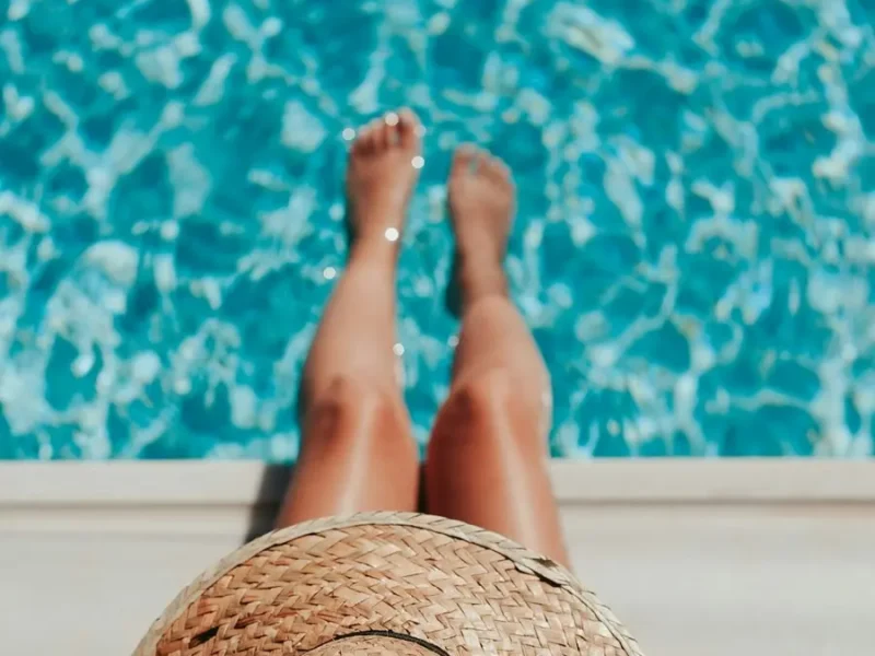 Girl dipping her toes in a serene pool for ultimate relaxation