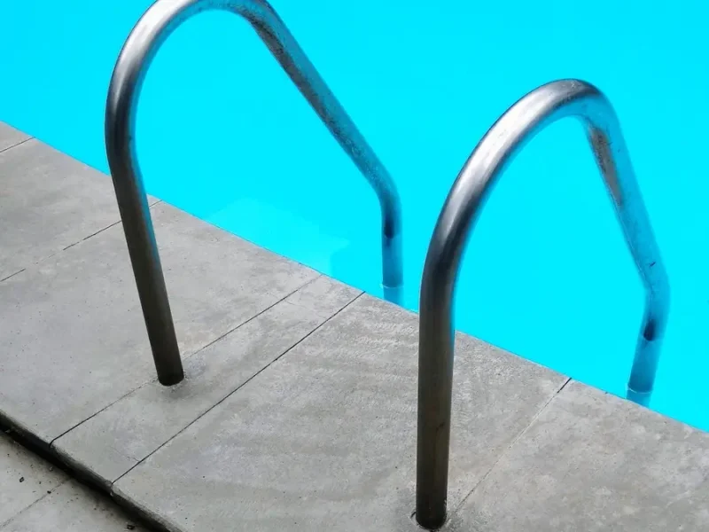 Silver pool handrails for safe entry and exit (ADA accessibility)