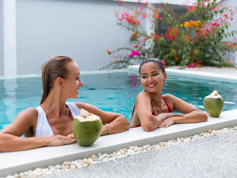 Two girls having fun in a perfectly clean pool